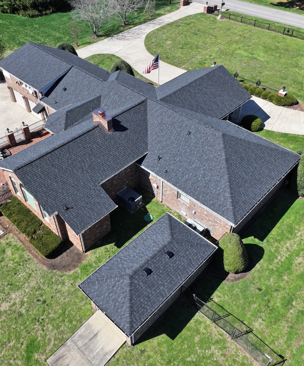 A residential home with a professionally installed architectural shingle roof showing dimensional texture and clean ridge lines.