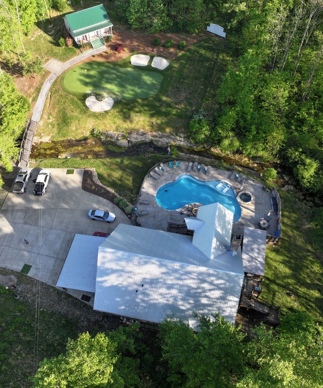 A commercial building with a large, flat, professionally maintained roof featuring HVAC units and proper drainage systems.